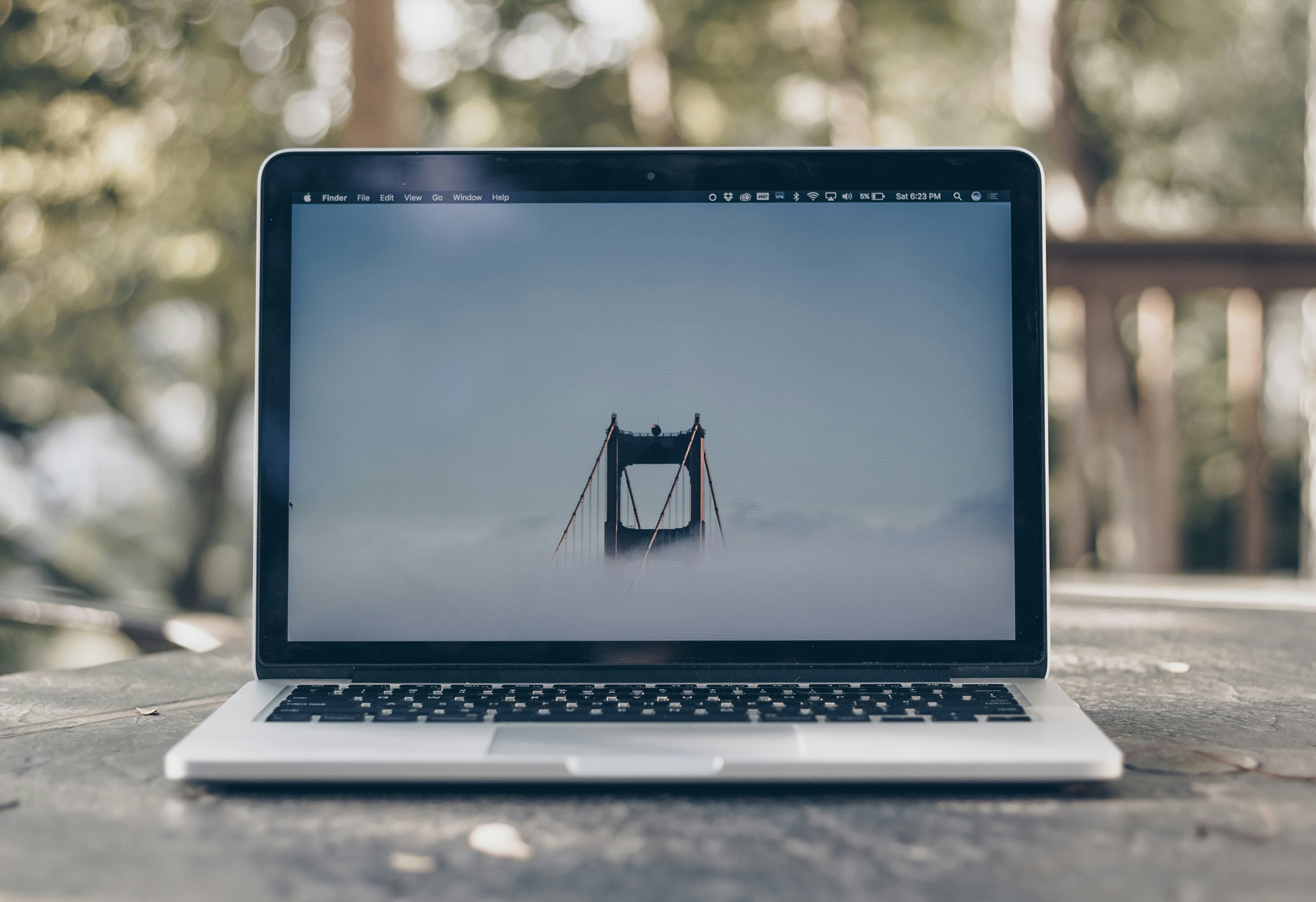 Open MacBook Pro on a grey desk, ready for building an app