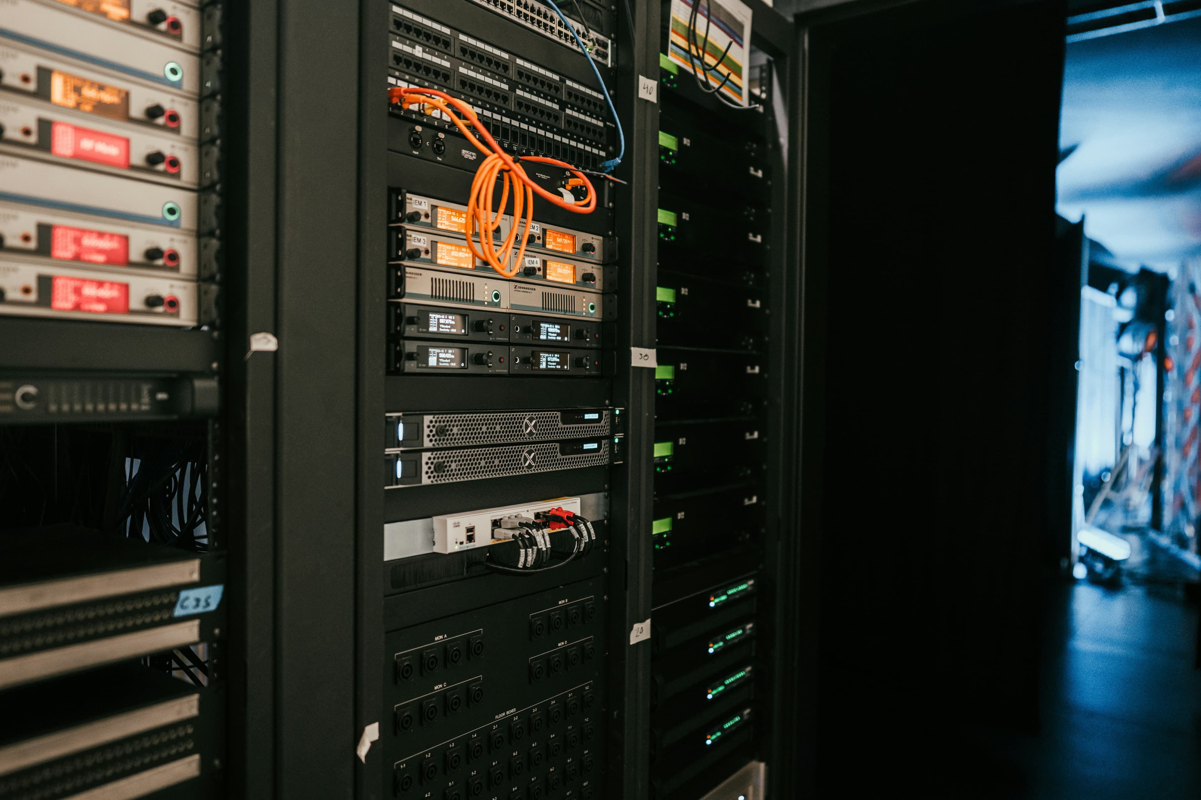 A rack of servers in a dimly lit server room